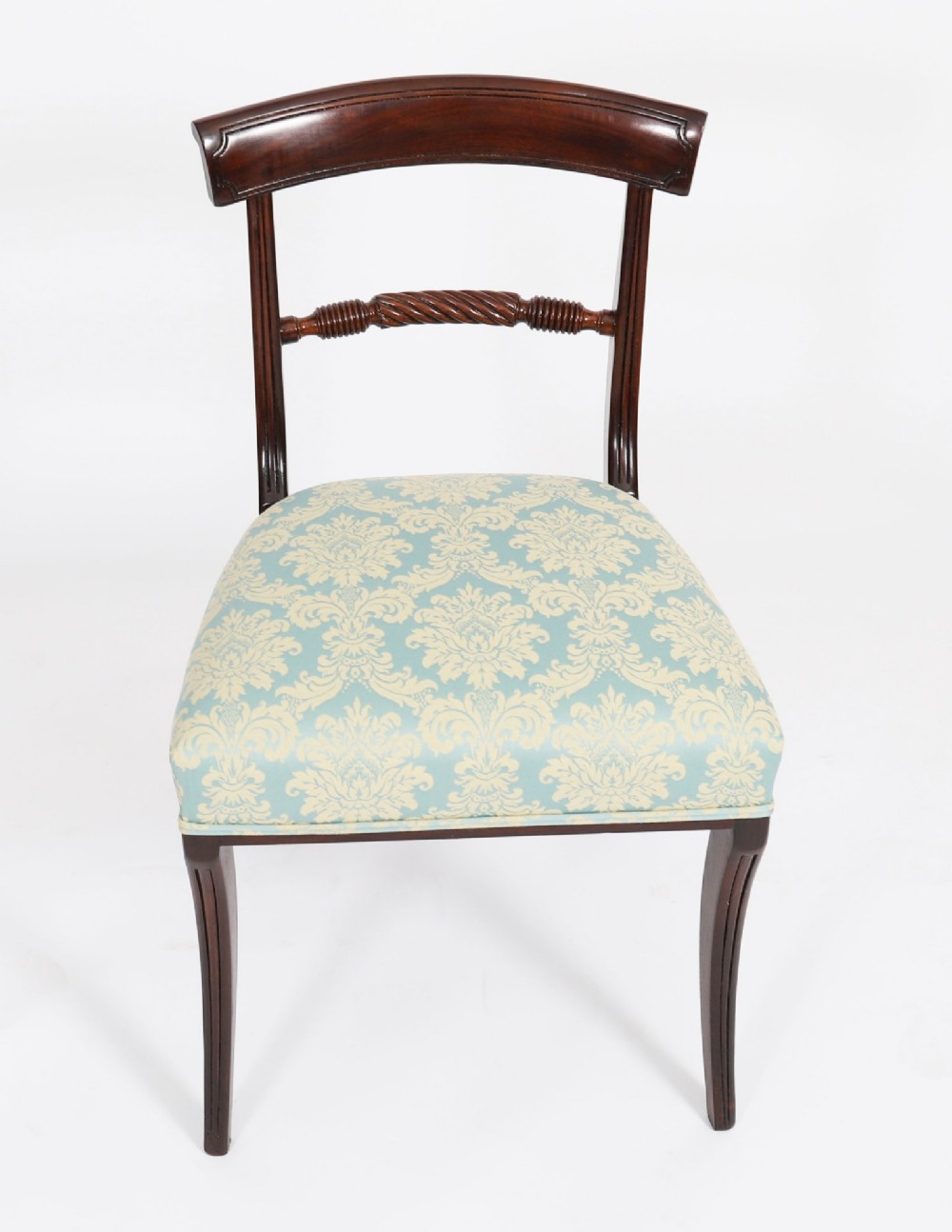 A set of eight Regency mahogany dining chairs, including two carvers, featuring curved top rails, rope-twist splats, and pale blue patterned upholstered seats. View XIII