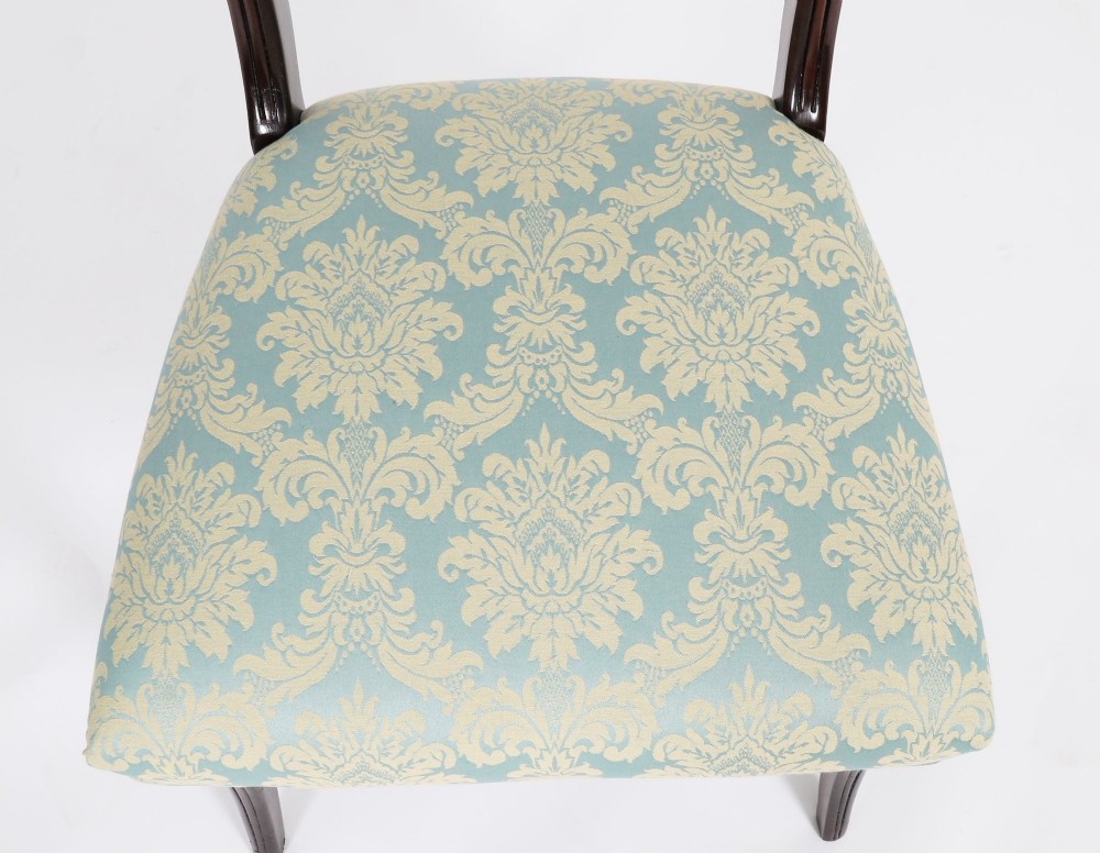 A set of eight Regency mahogany dining chairs, including two carvers, featuring curved top rails, rope-twist splats, and pale blue patterned upholstered seats. View XV