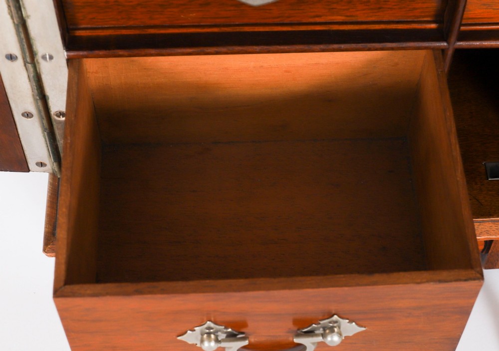 An antique Victorian walnut tabletop collectors cabinet featuring a front styled with vintage book spines, turned columns, turned feet, and a central finial top. View XIII