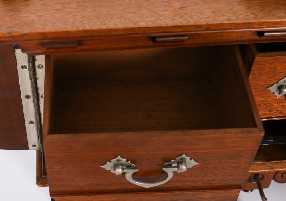 An antique Victorian walnut tabletop collectors cabinet featuring a front styled with vintage book spines, turned columns, turned feet, and a central finial top. View XIV