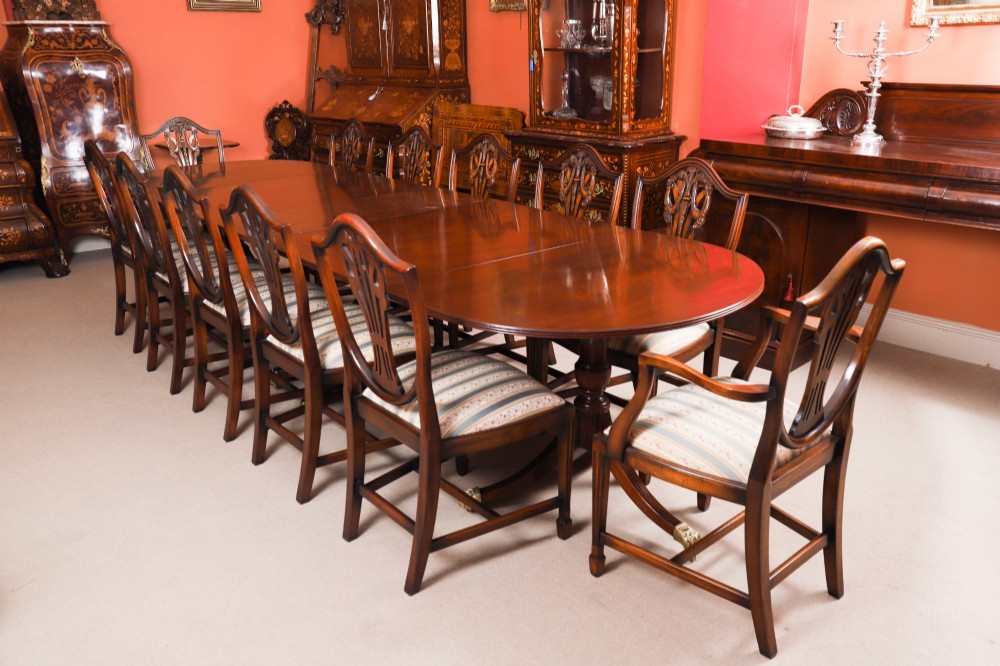 An extended mahogany Regency Revival triple pillar dining table with reeded legs and brass paw castors. View III