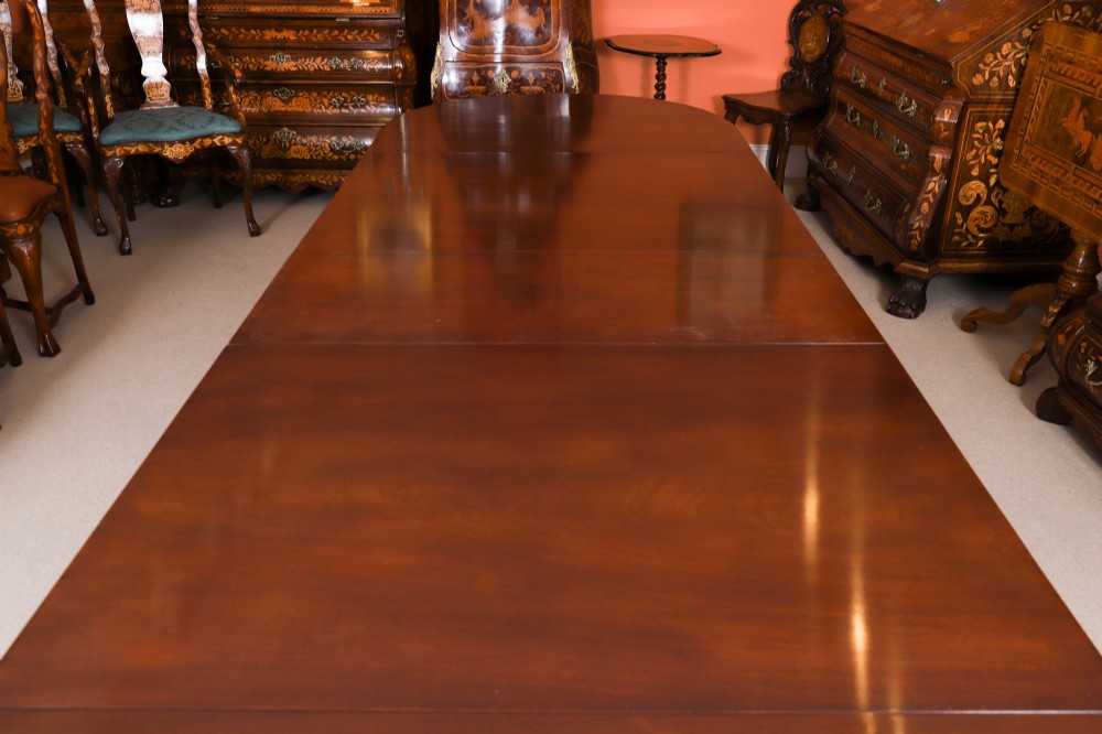 An extended mahogany Regency Revival triple pillar dining table with reeded legs and brass paw castors. View XII