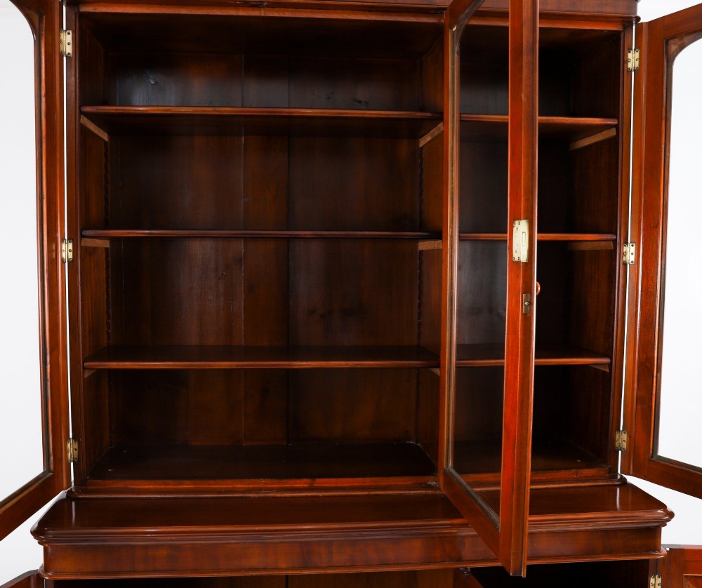 A large 19th-century Victorian flame mahogany library bookcase featuring a glazed three-door upper section filled with books above a solid three-door cupboard base. View XIII