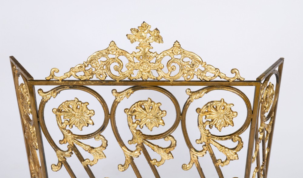 A nineteenth-century French Louis XIV Revival three-panel folding fire screen made from gilt brass featuring intricate floral scrollwork and an ornate cresting motif. View IV
