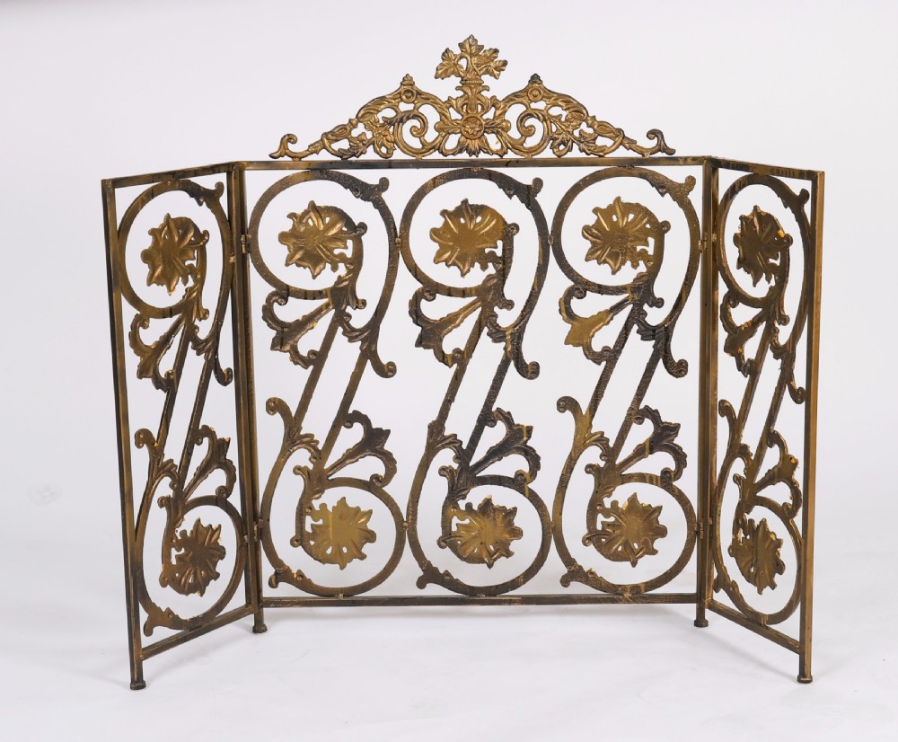 A nineteenth-century French Louis XIV Revival three-panel folding fire screen made from gilt brass featuring intricate floral scrollwork and an ornate cresting motif. View VIII