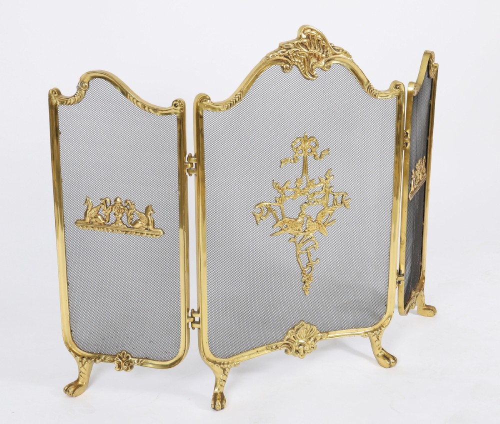 A three-fold French Rococo gilt bronze fire screen featuring fine wire mesh panels, ornate scrollwork cresting, and a central flaming torch motif. View II