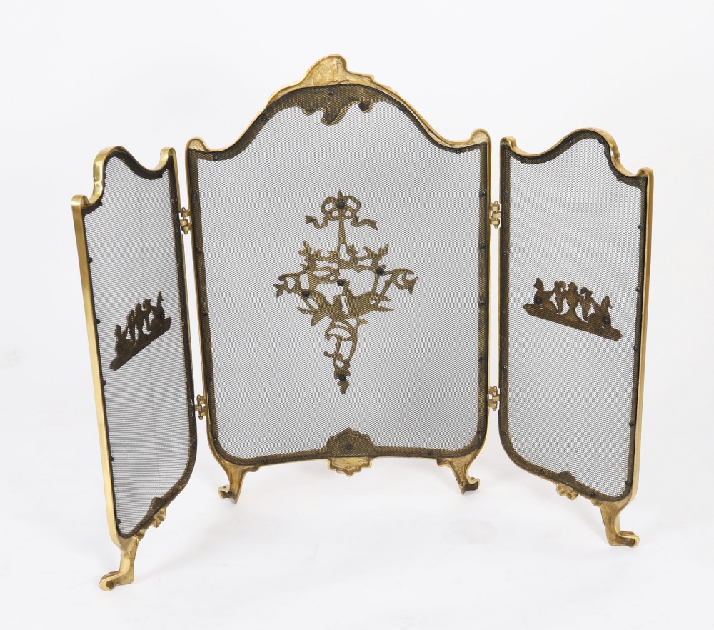 A three-fold French Rococo gilt bronze fire screen featuring fine wire mesh panels, ornate scrollwork cresting, and a central flaming torch motif. View X