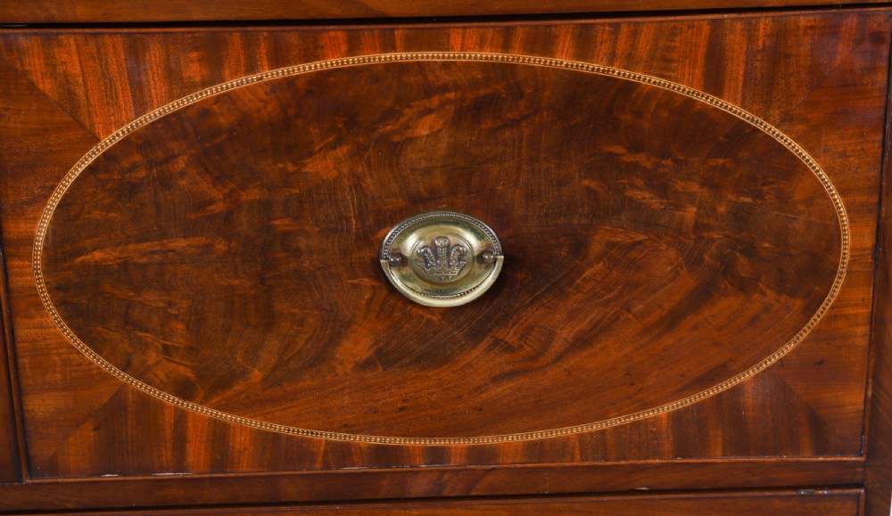 A George III flame mahogany secretaire bookcase featuring an arched pediment, astragal glazed doors, and lower drawers on bracket feet. View VII