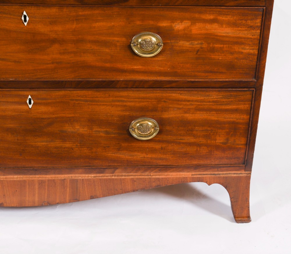 A George III flame mahogany secretaire bookcase featuring an arched pediment, astragal glazed doors, and lower drawers on bracket feet. View X