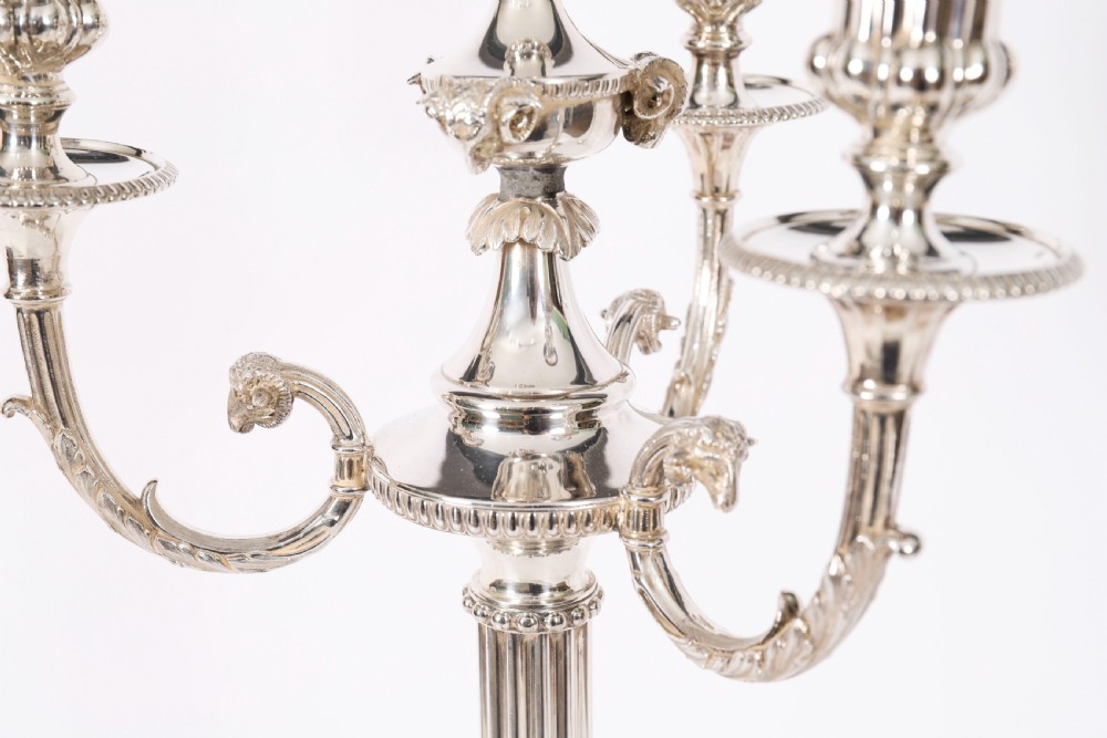 A pair of silver-plated four-light candelabra with fluted columns, scroll branches, and laurel wreath detailing on square bases. View IV