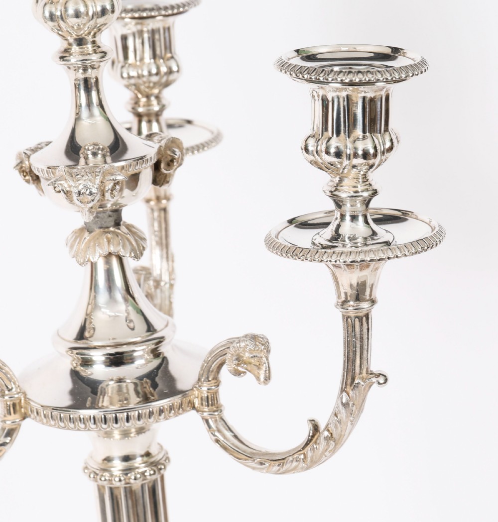 A pair of silver-plated four-light candelabra with fluted columns, scroll branches, and laurel wreath detailing on square bases. View VI