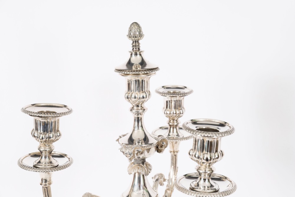 A pair of silver-plated four-light candelabra with fluted columns, scroll branches, and laurel wreath detailing on square bases. View VII