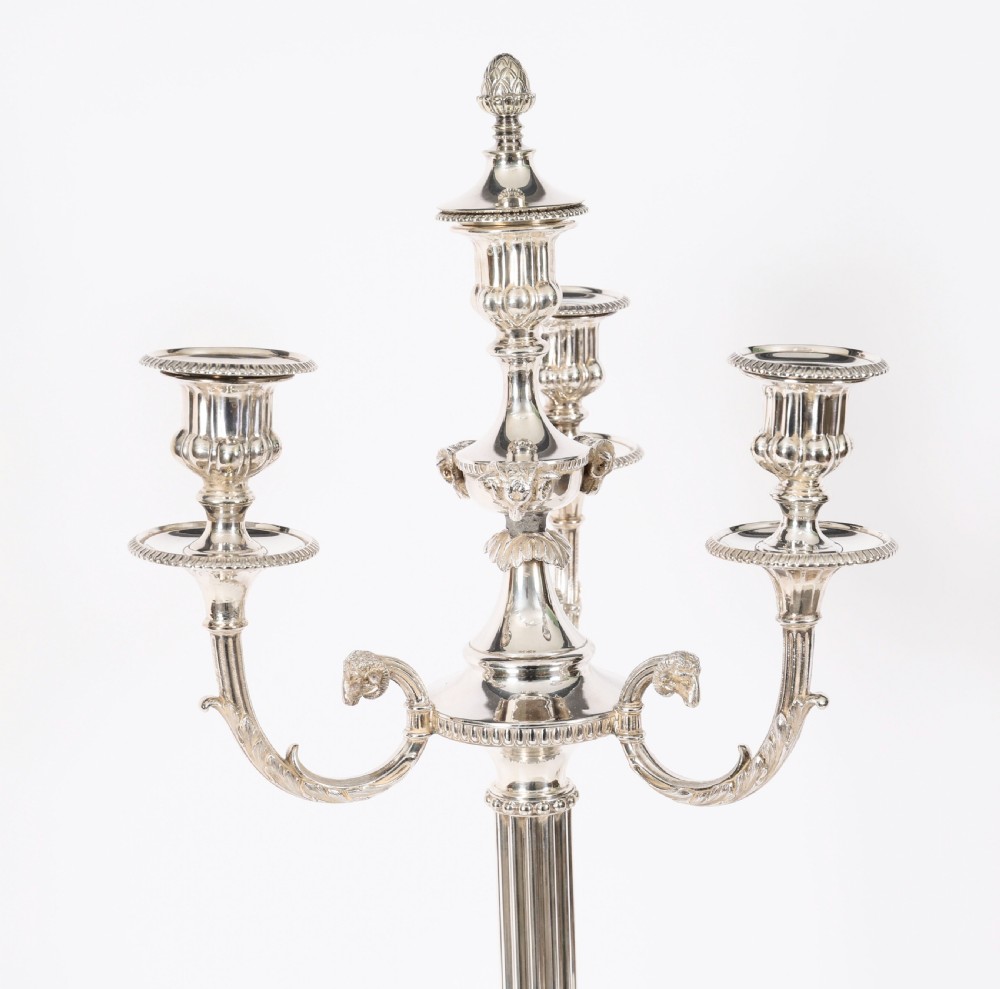 A pair of silver-plated four-light candelabra with fluted columns, scroll branches, and laurel wreath detailing on square bases. View VIII