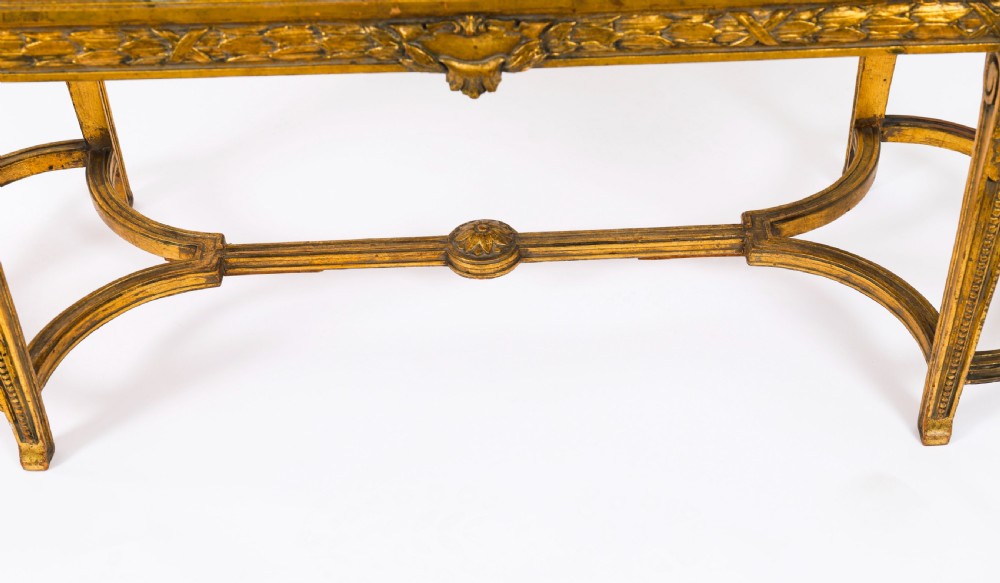 An early 20th-century oval French Louis XVI style giltwood low table featuring an inlaid tapestry top under glass and carved legs connected by a stretcher. View XIII