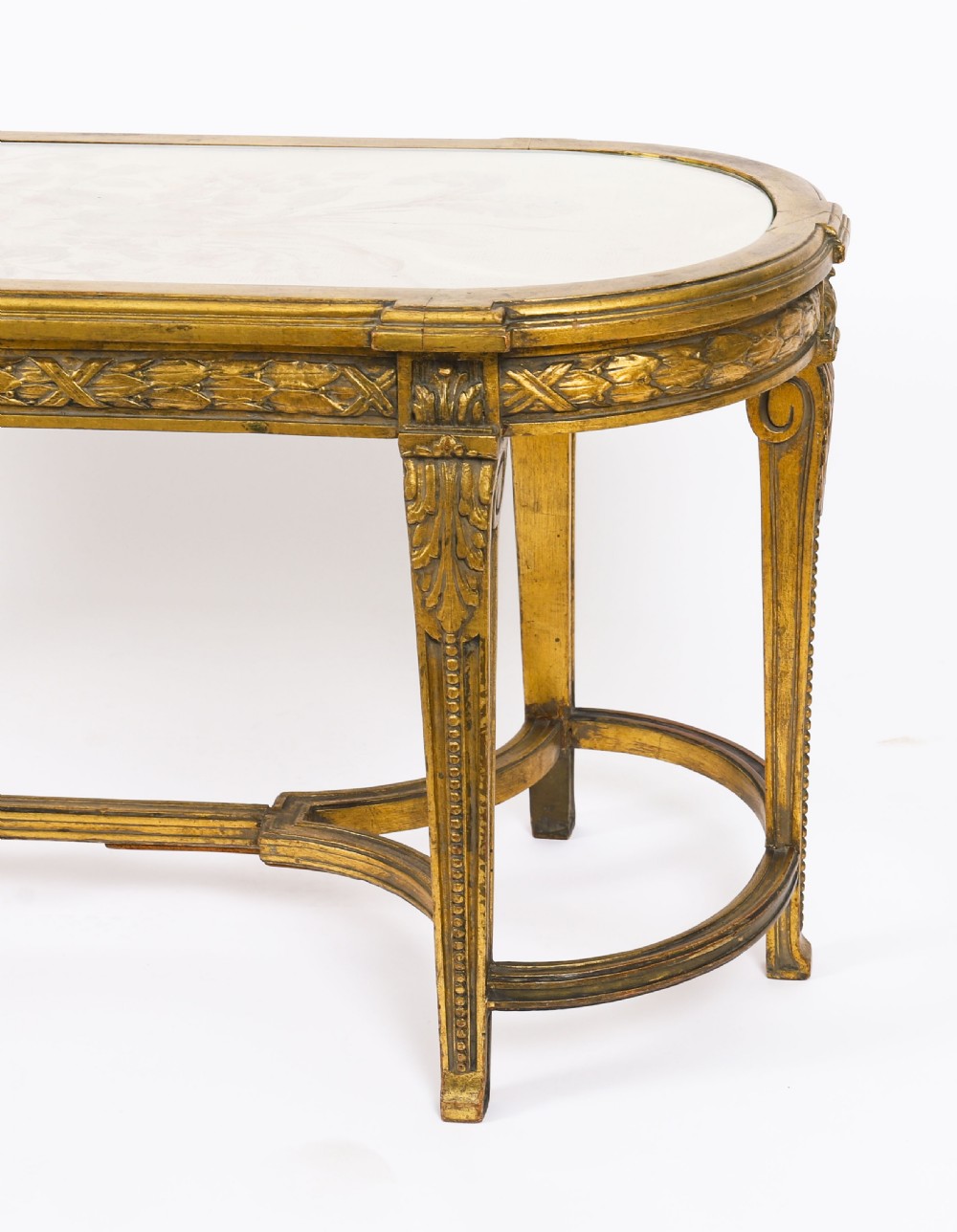 An early 20th-century oval French Louis XVI style giltwood low table featuring an inlaid tapestry top under glass and carved legs connected by a stretcher. View XIV