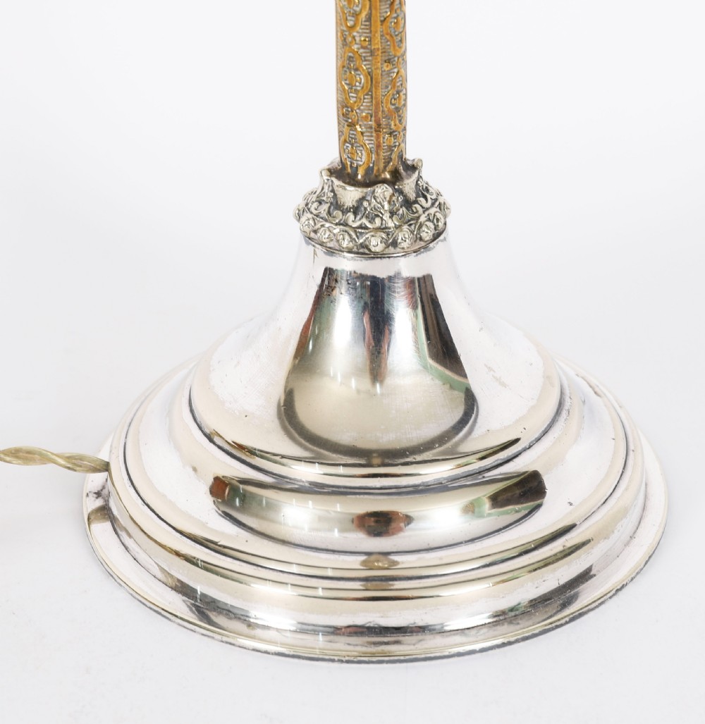 A nineteenth-century silver-plated table lamp base with a parcel gilt patterned column and stepped circular foot. View VII
