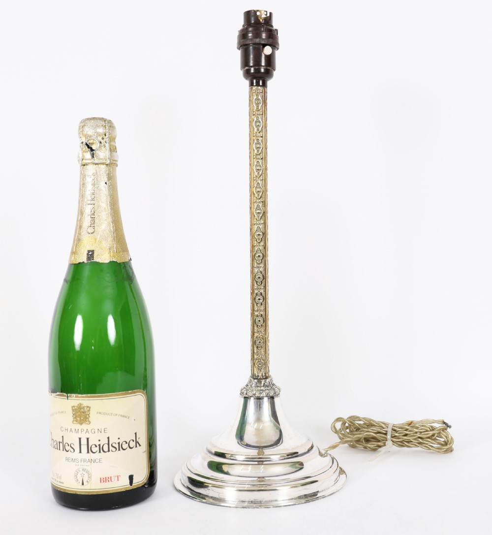 A nineteenth-century silver-plated table lamp base with a parcel gilt patterned column and stepped circular foot. View XI