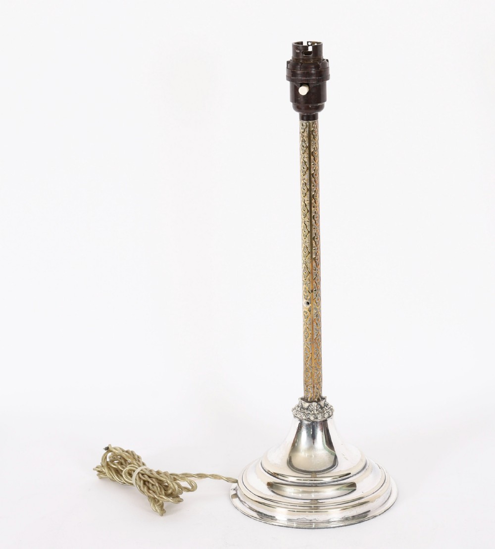 A nineteenth-century silver-plated table lamp base with a parcel gilt patterned column and stepped circular foot. View XII