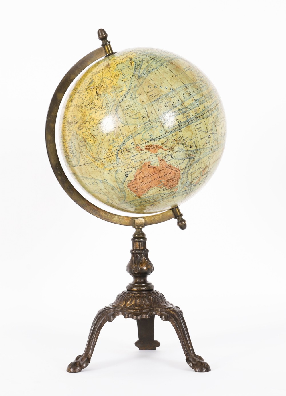 An antique 1880 French terrestrial globe mounted on a brass half-meridian ring and a decorative cast metal tripod base.