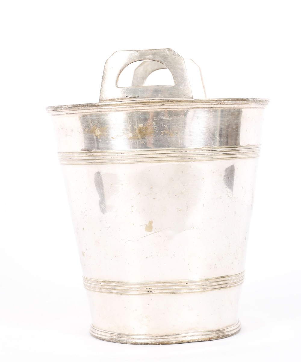 An Art Deco silver-plated champagne cooler featuring angular raised handles, horizontal reeded bands, and an engraved circular crest. View V