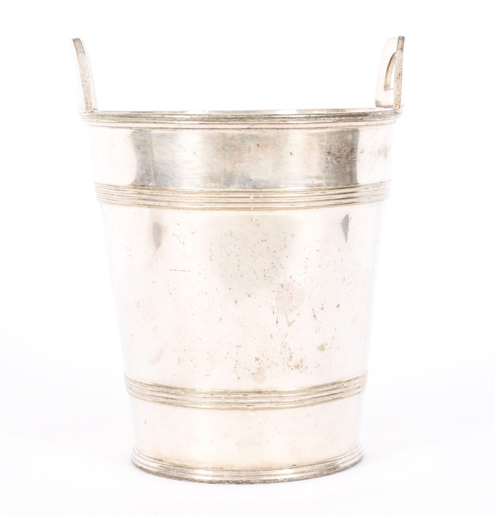 An Art Deco silver-plated champagne cooler featuring angular raised handles, horizontal reeded bands, and an engraved circular crest. View VIII