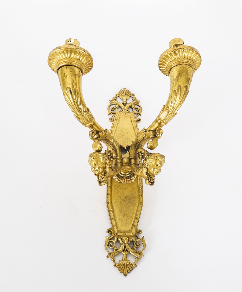 A pair of antique French Louis XIV Revival two-branch gilt bronze ormolu wall sconces decorated with cherub motifs. View VI
