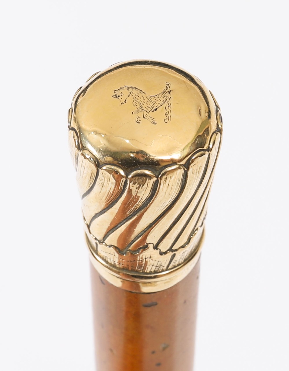 A straight polished wooden walking cane featuring a decorated 18ct gold pommel handle and a metal ferrule tip at the base. View V