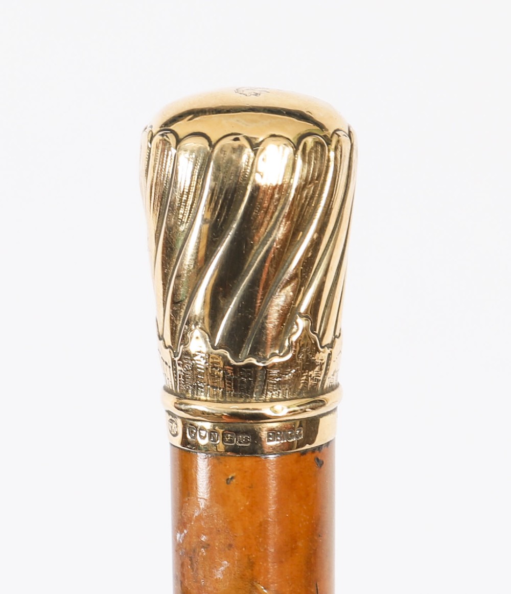 A straight polished wooden walking cane featuring a decorated 18ct gold pommel handle and a metal ferrule tip at the base. View XIII