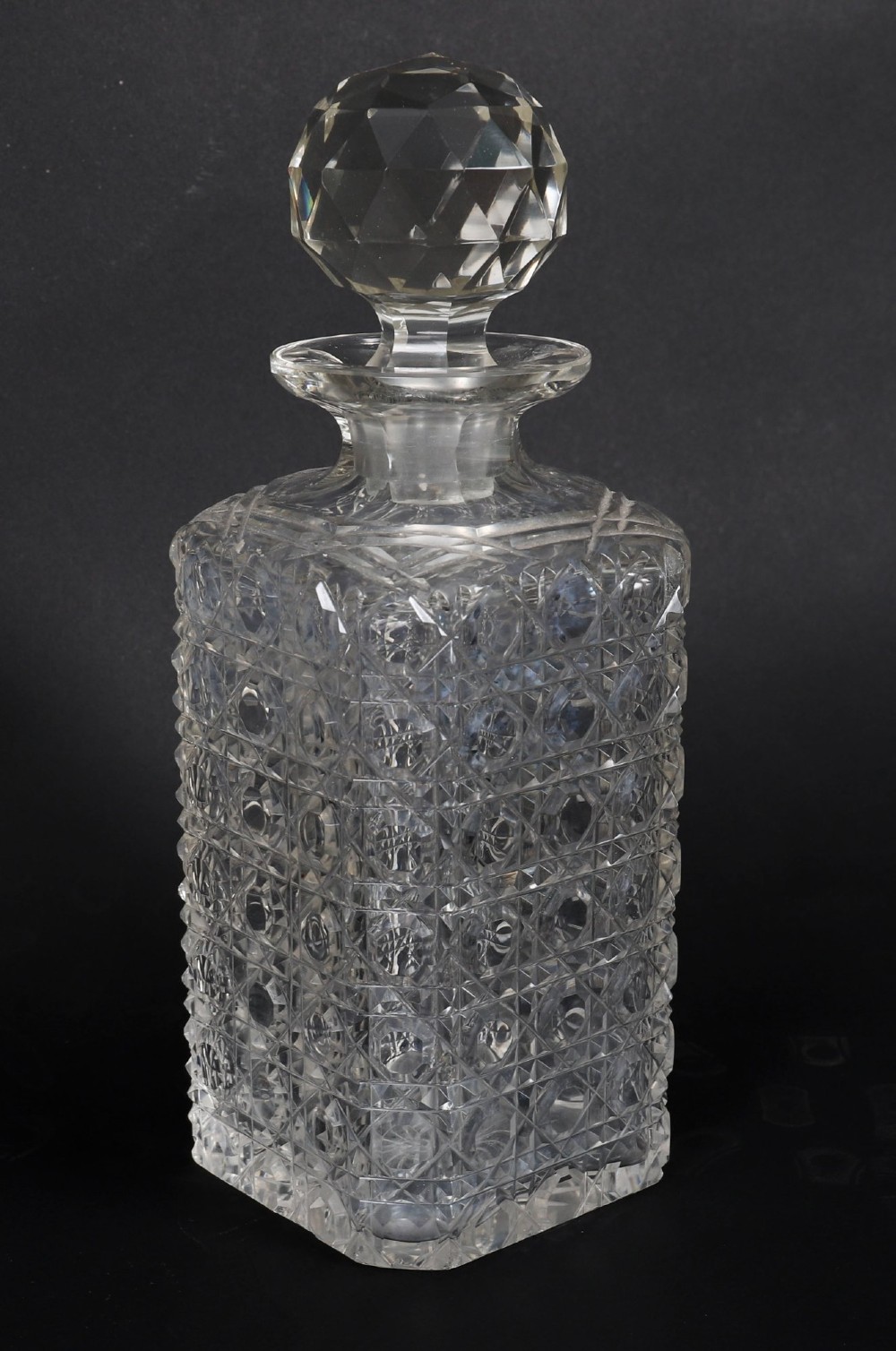 An antique blonde oak tantalus featuring three square cut-glass decanters set against a mirror back, decorative silver-plated corner mounts, and a lower drawer with a key. View XIII