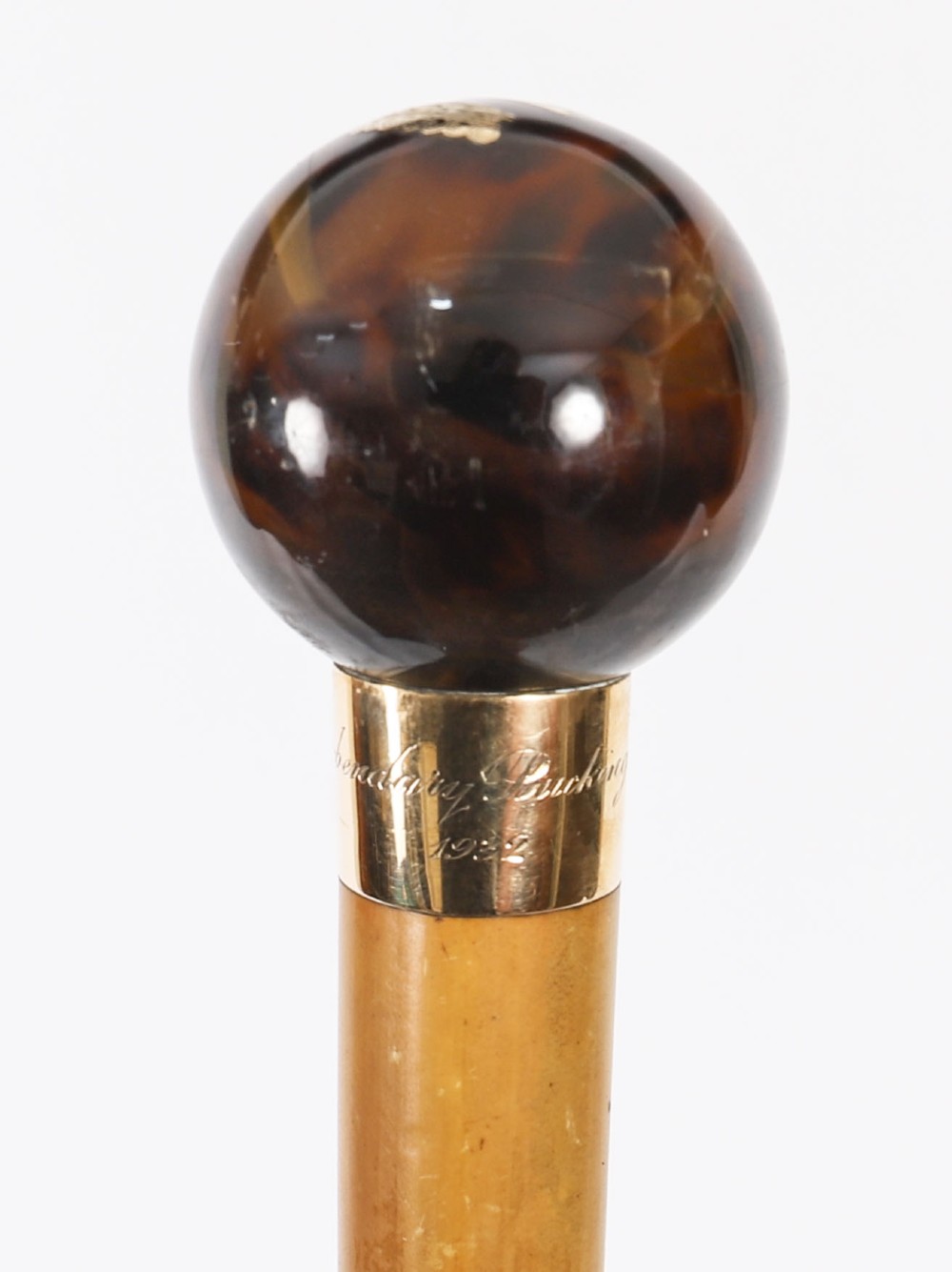 An antique Victorian wooden walking stick featuring a dark spherical pommel, an 18ct gold collar band, and a tapered brown shaft. View IV