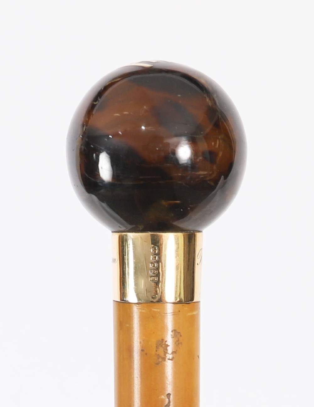 An antique Victorian wooden walking stick featuring a dark spherical pommel, an 18ct gold collar band, and a tapered brown shaft. View IX
