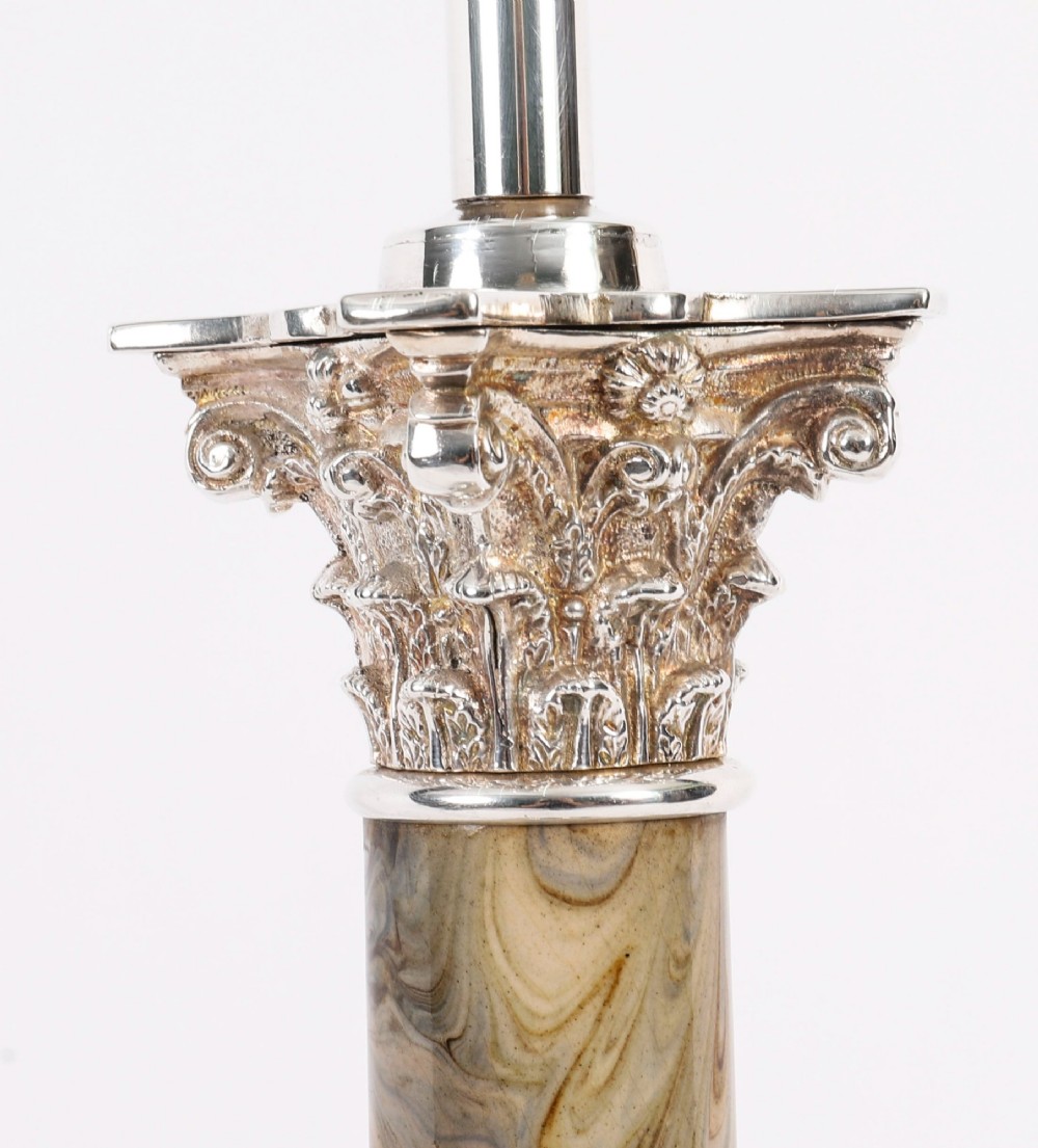 A silver-plated Corinthian column table lamp with a marbled shaft set upon a stepped square base. View IX