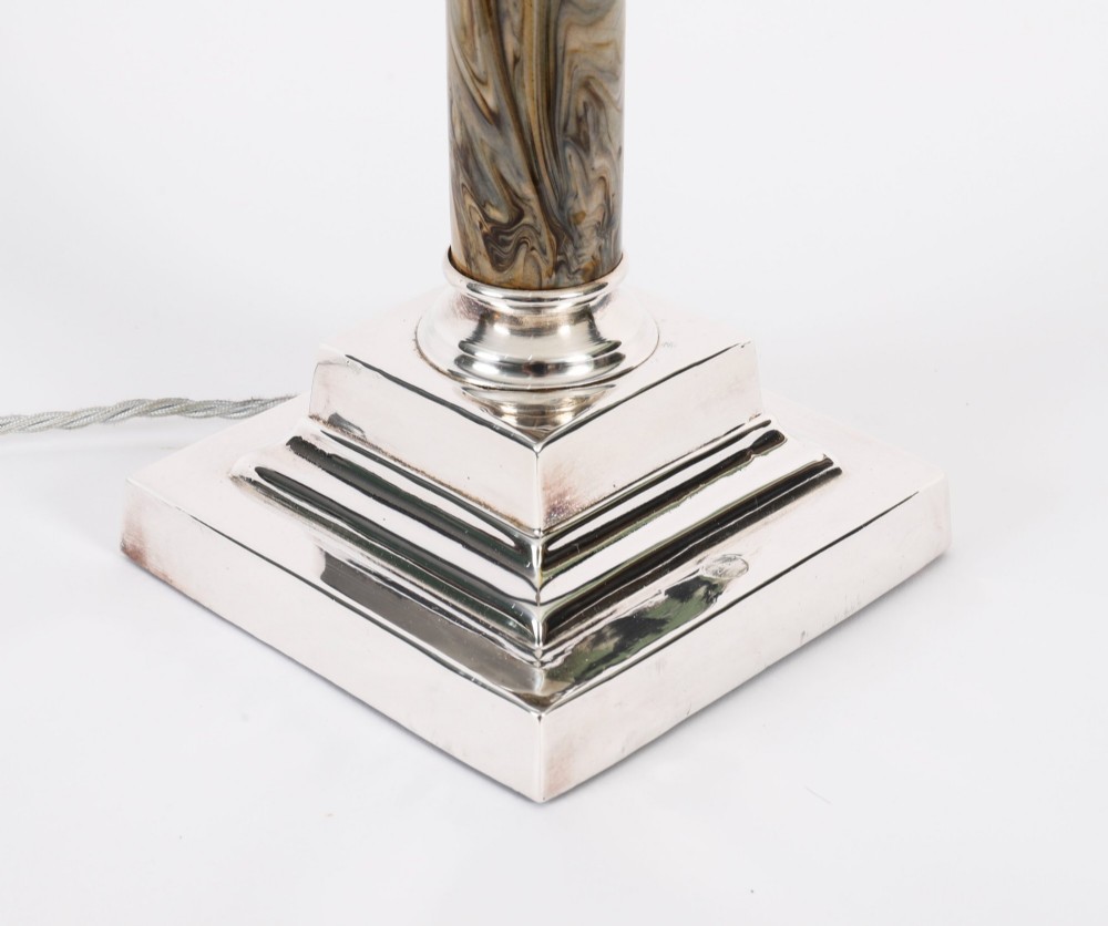 A silver-plated Corinthian column table lamp with a marbled shaft set upon a stepped square base. View XI