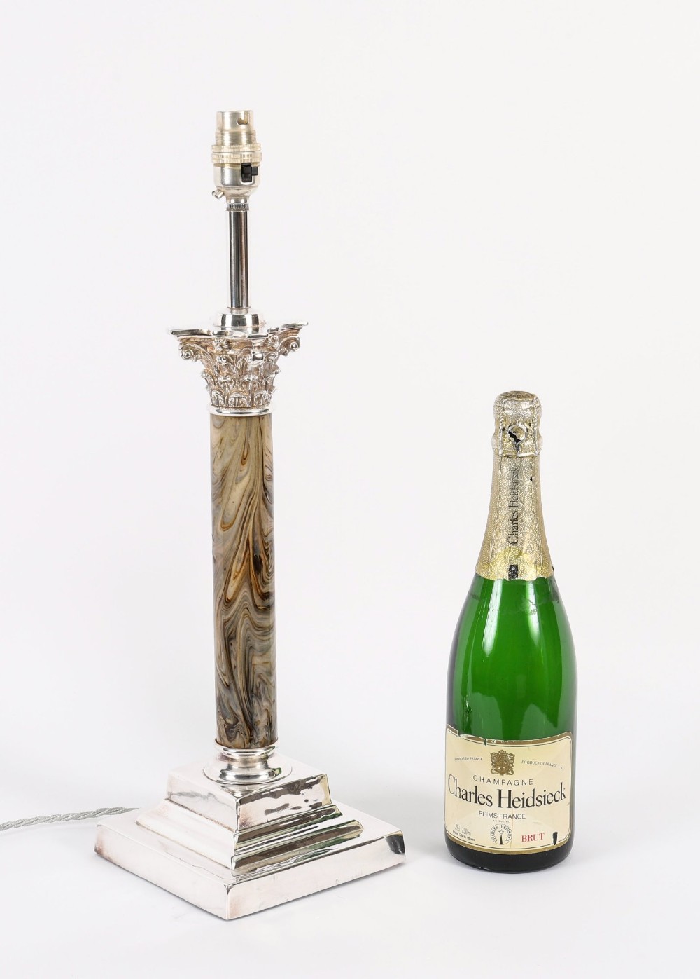 A silver-plated Corinthian column table lamp with a marbled shaft set upon a stepped square base. View XIII