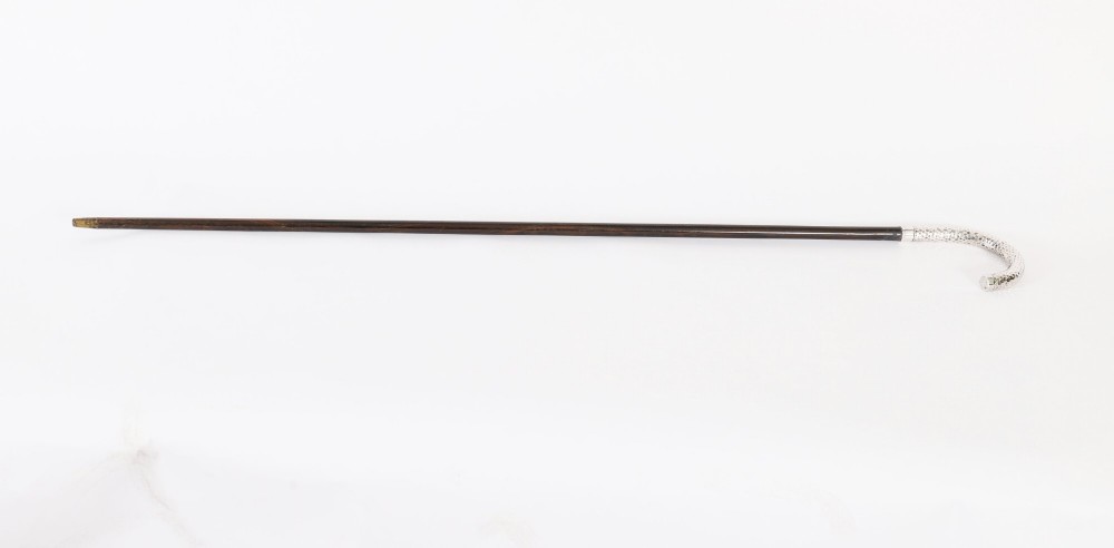 An antique French walking cane featuring a hand-hammered crook-shaped silver handle mounted on a dark wooden shaft. View II
