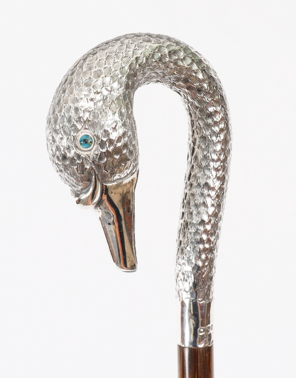 An Edwardian walking stick featuring a sterling silver swan head handle mounted on a dark wood shaft. View X