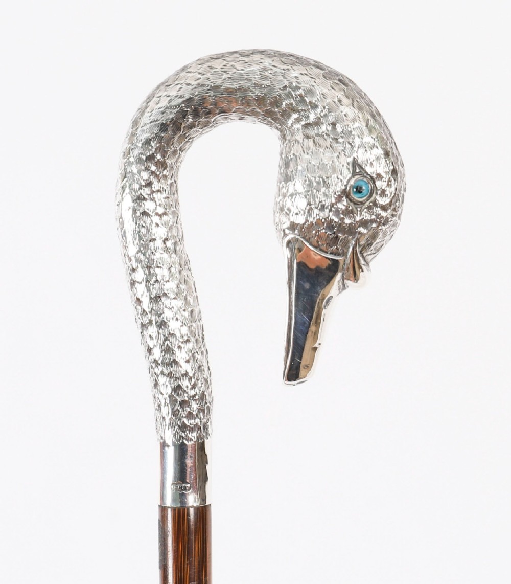 An Edwardian walking stick featuring a sterling silver swan head handle mounted on a dark wood shaft. View XI