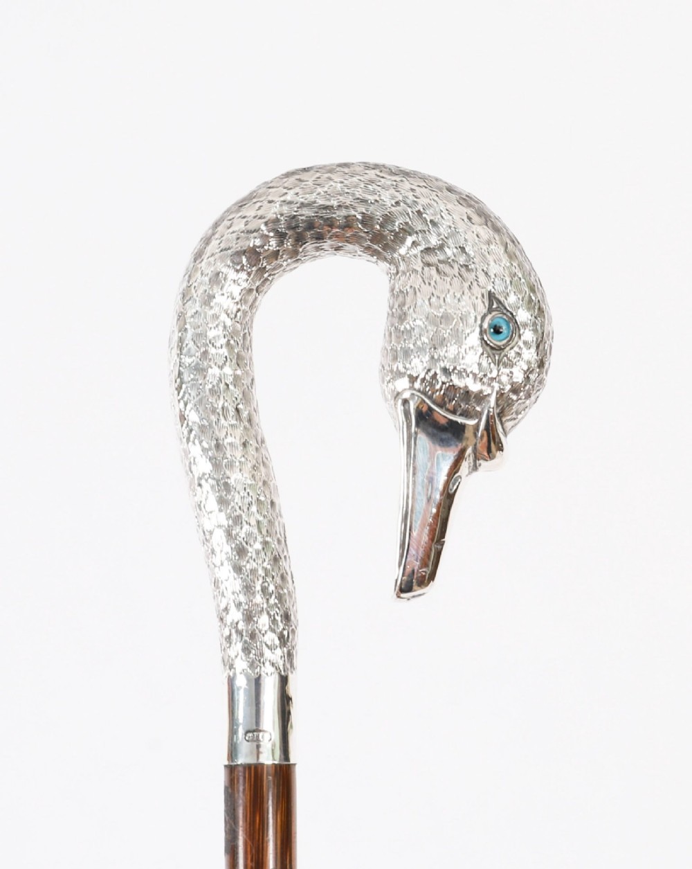 An Edwardian walking stick featuring a sterling silver swan head handle mounted on a dark wood shaft. View XII