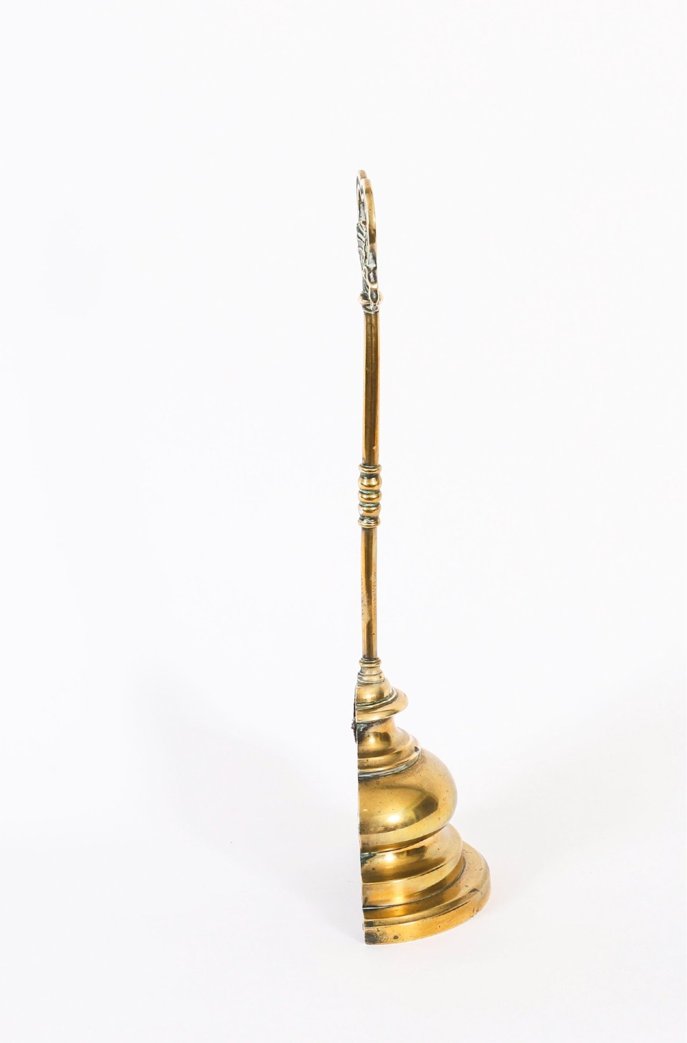 A 19th-century Victorian brass door stop featuring a tall shaft topped with a heart-shaped handle and supported by a heavy, tiered circular base. View VIII