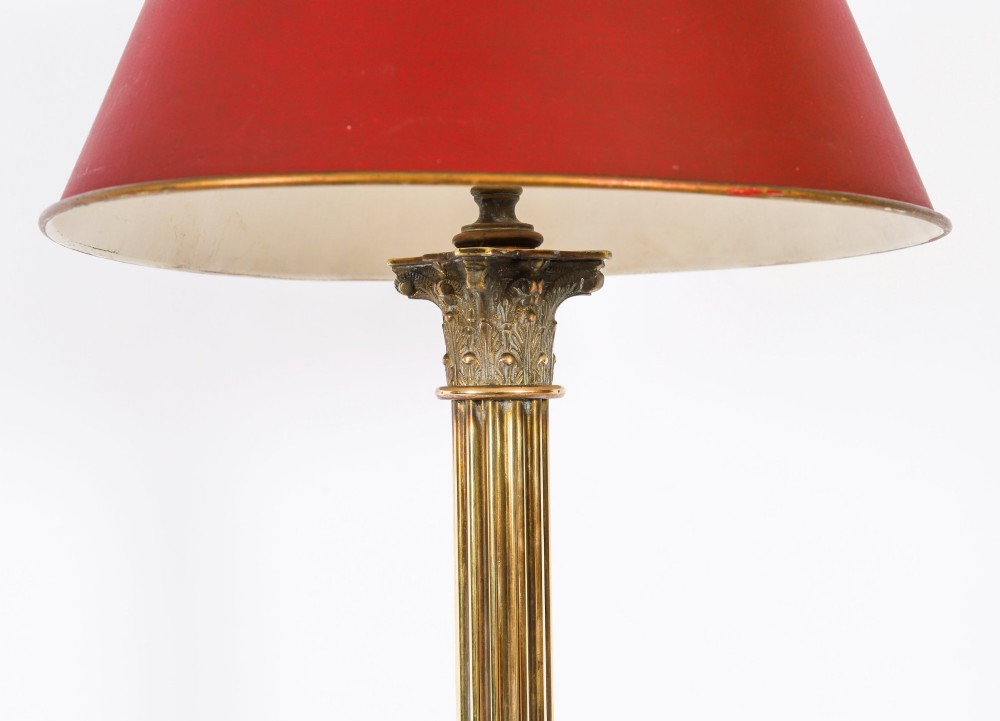 A pair of late nineteenth-century brass Corinthian column table lamps featuring fluted stems, stepped bases, wooden plinths, and conical red lampshades. View VI