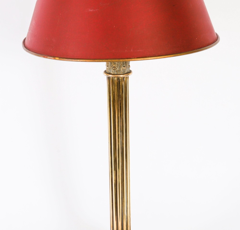 A pair of late nineteenth-century brass Corinthian column table lamps featuring fluted stems, stepped bases, wooden plinths, and conical red lampshades. View XI