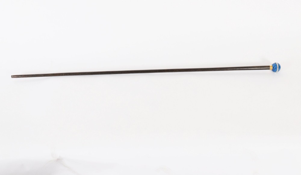 An Edwardian walking cane featuring a spherical lapis lazuli pommel accented with a faceted crystal band and a ribbed gold collar on a dark hardwood shaft. View II