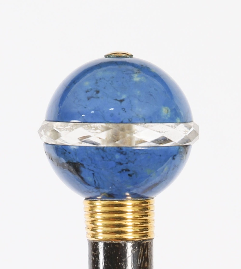 An Edwardian walking cane featuring a spherical lapis lazuli pommel accented with a faceted crystal band and a ribbed gold collar on a dark hardwood shaft. View V