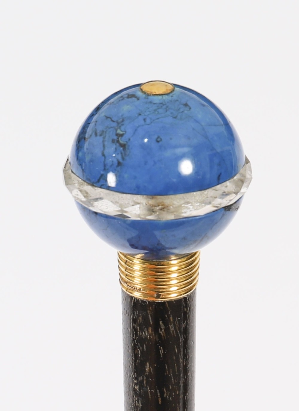 An Edwardian walking cane featuring a spherical lapis lazuli pommel accented with a faceted crystal band and a ribbed gold collar on a dark hardwood shaft. View VII