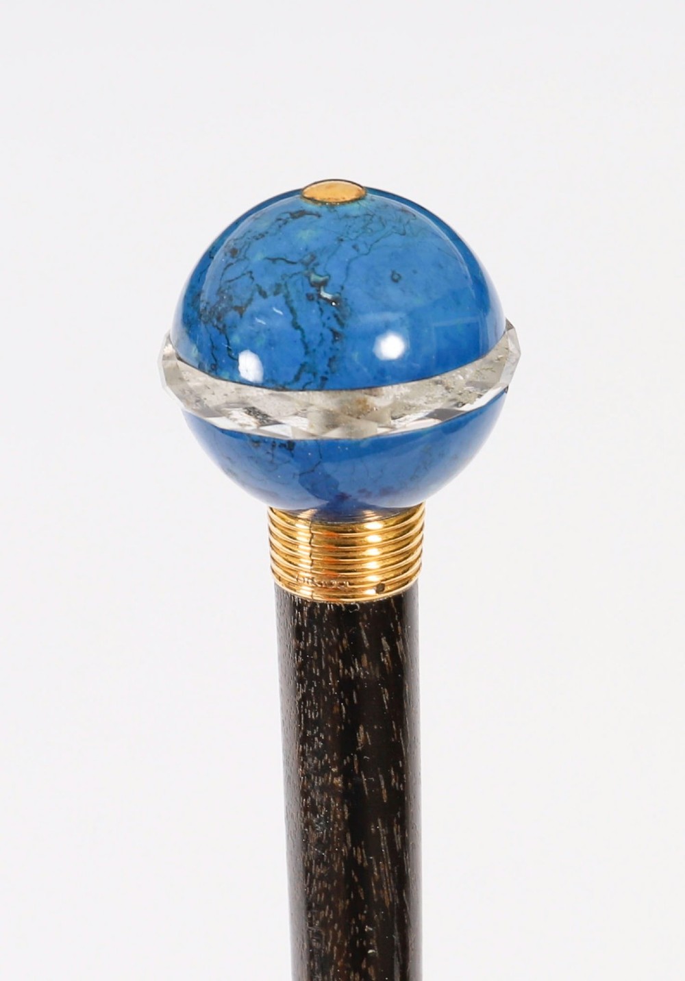 An Edwardian walking cane featuring a spherical lapis lazuli pommel accented with a faceted crystal band and a ribbed gold collar on a dark hardwood shaft. View VIII