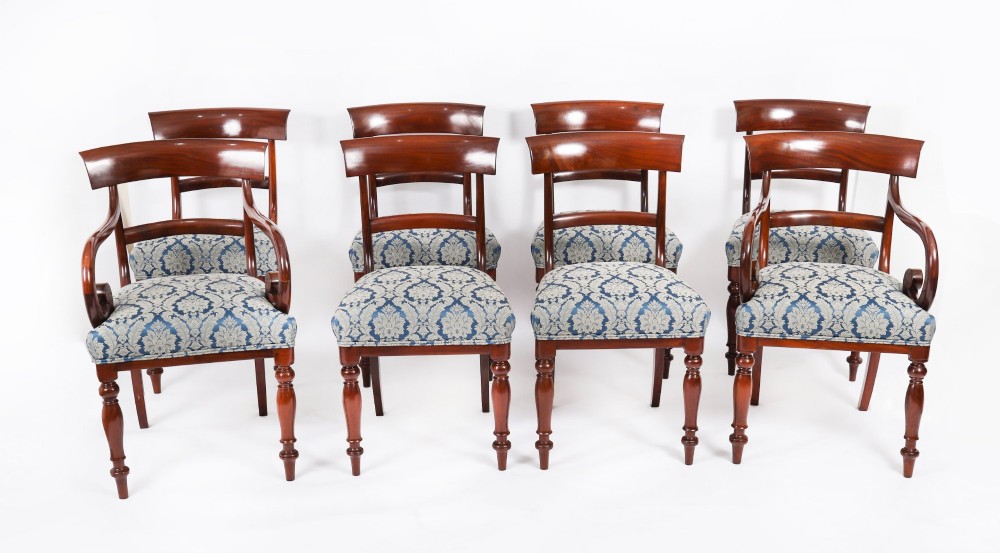 A set of eight William IV mahogany barback dining chairs with blue damask patterned fabric upholstery and turned front legs.