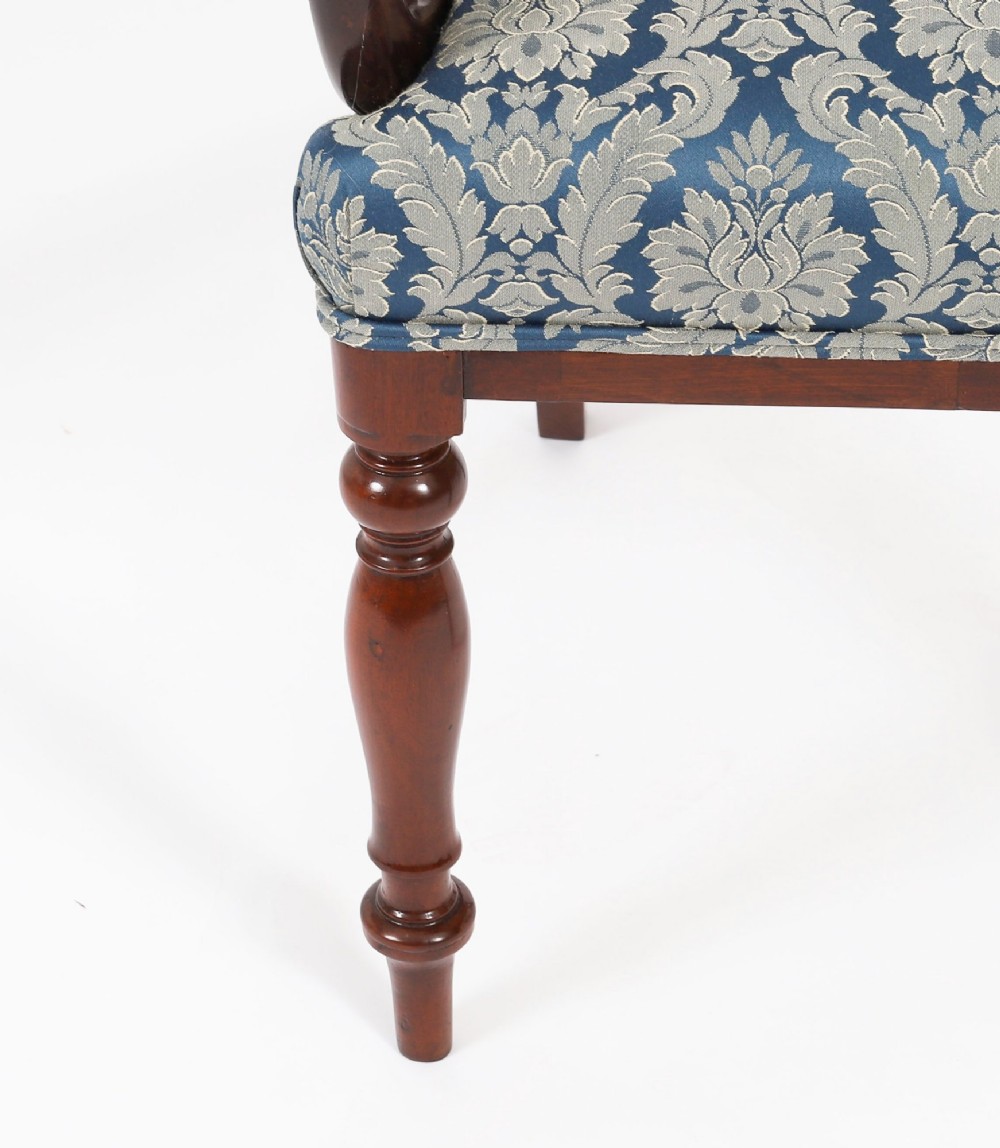 A set of eight William IV mahogany barback dining chairs with blue damask patterned fabric upholstery and turned front legs. View IV