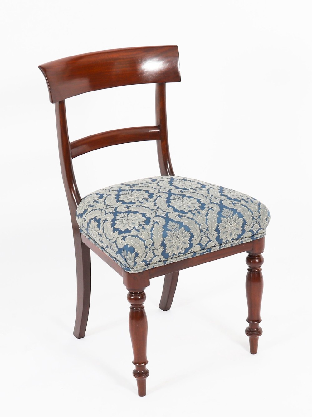 A set of eight William IV mahogany barback dining chairs with blue damask patterned fabric upholstery and turned front legs. View IX