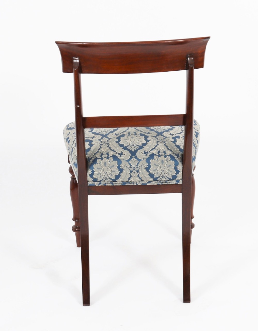 A set of eight William IV mahogany barback dining chairs with blue damask patterned fabric upholstery and turned front legs. View XI