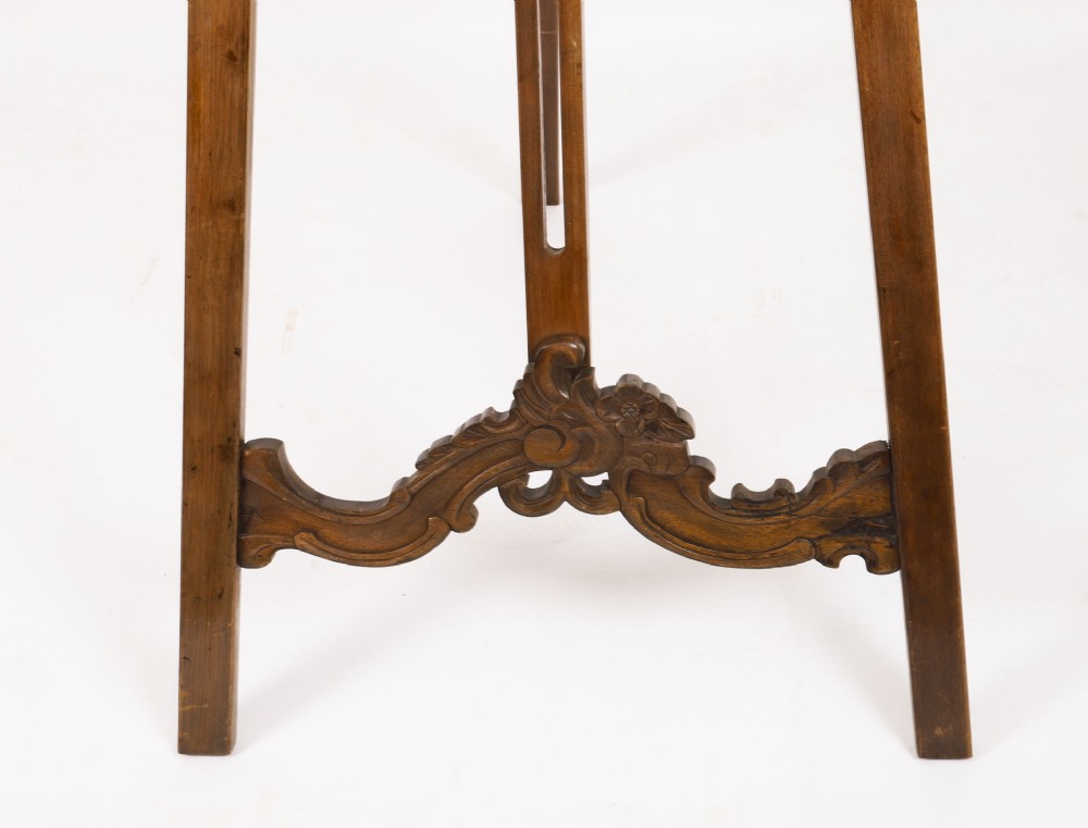 A 19th-century carved walnut artist easel featuring an ornate Rococo Revival scrollwork crest and an adjustable ledge on a tripod frame. View IX